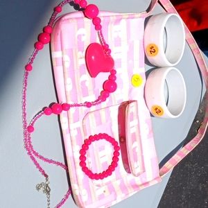 Pink and white beautiful bag with white brackets pink necklace and a pink small